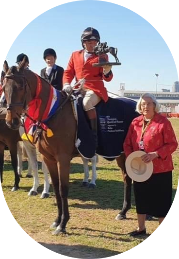 Kathleen presenting Gerard Hurry with the inaugural Darren Green Memorial Trophy for the most successful horse and rider in the hunting competition at the Melbourne Royal Show in 2019.